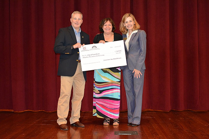 Arkansas Lt. Gov. Tim Griffin, left, and Department of Arkansas Heritage Director Stacy Hurst, right, present a grant to Texarkana, Ark., Assistant City Planner Mary Beck. The city of Texarkana and Main Street Texarkana recently received nearly $60,000 in grants from the state Historic Preservation Program.