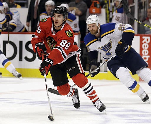 In this April 19, 2016, file photo, Chicago Blackhawks left wing Teuvo Teravainen (86) skates with the puck against St. Louis Blues center Kyle Brodziak (28) during the first period in Game 4 of an NHL hockey first-round Stanley Cup playoff series in Chicago.