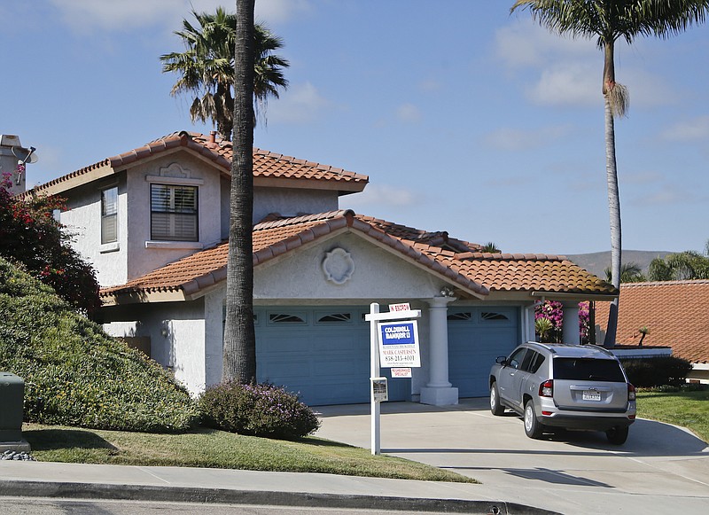 This Thursday, May 26, 2016, photo shows a home with an "In Escrow" sign in Encinitas, Calif.