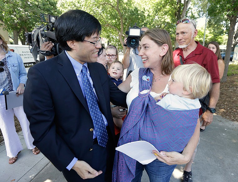 California state Sen. Richard Pan, D-Sacramento, is thanked by Leah Russin, holding her son Leo, 2, after Pan's bill requiring nearly all school children to be vaccinated was signed last year by Gov. Jerry Brown. The bill, by Pan and Sen. Ben Allen, D-Santa Monica, was introduced after a measles outbreak at Disneyland and will take effect Friday.