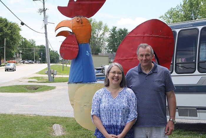 Mike Cuno and his wife, Teresa, pose with their rooster statue at the Rooster Creek Company.