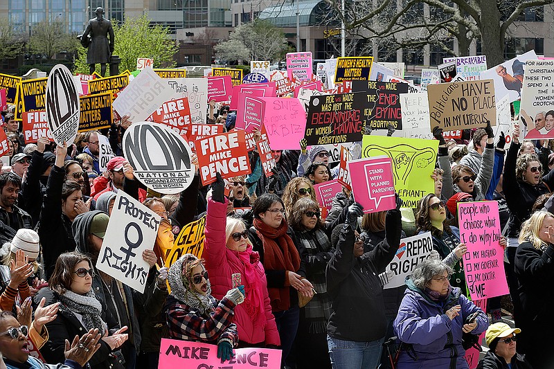In this April 9, 2016, file photo, hundreds of abortion rights supporters gather at the Indiana Statehouse in Indianapolis to protest an anti-abortion law signed by Gov. Mike Pence, that is among the most restrictive in the U.S. U.S. District Judge Tanya Walton Pratt has said she will issue a ruling before Friday, July 1, when the law adopted this year by the GOP-dominated Legislature is set to take effect. 