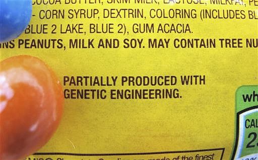 This April 8, 2016 file photo shows a new disclosure statement which reads, "PARTIALLY PRODUCED WITH GENETIC ENGINEERING" on a package of candy in Montpelier, Vt. Vermont became the first U.S. state to require the labeling of foods made with genetically modified ingredients on Friday, July 1, 2016. 