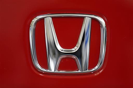 This Feb. 14, 2013, file photo shows a Honda logo on the trunk of a Honda automobile at the Pittsburgh Auto Show, in Pittsburgh.