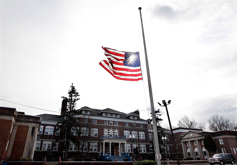 An American flag flies at half-staff in 2012 in front of the Whitney E. Houston Academy of Creative and Performing Arts in East Orange, New Jersey, to honor the performing artist Whitney Houston, who had died the previous day. 
