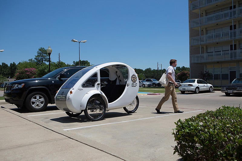  Holden Fleming with the City of Texarkana, Texas, delivers fresh produce from the Texas-side Famers' Market to Robison Terrace Thursday afternoon. Fleming makes the delivery in the city's ELF, an electric hybrid bicycle.  