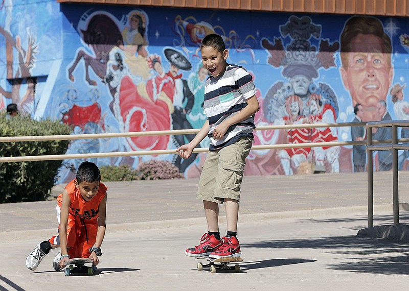 In this March 27, 2016 photo, kids ride around the Chamizal National Memorial in El Paso, Texas, during their Easter outing at the park.