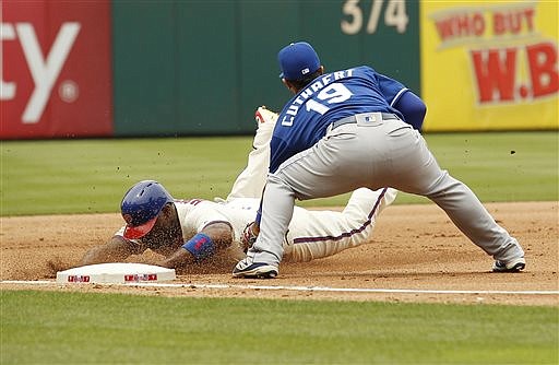 Philadelphia Phillies' Ryan Howard, left, is tagged out at third base by Kansas City Royals' Cheslor Cuthbert during the fourth inning of a baseball game Sunday, July 3, 2016, in Philadelphia.