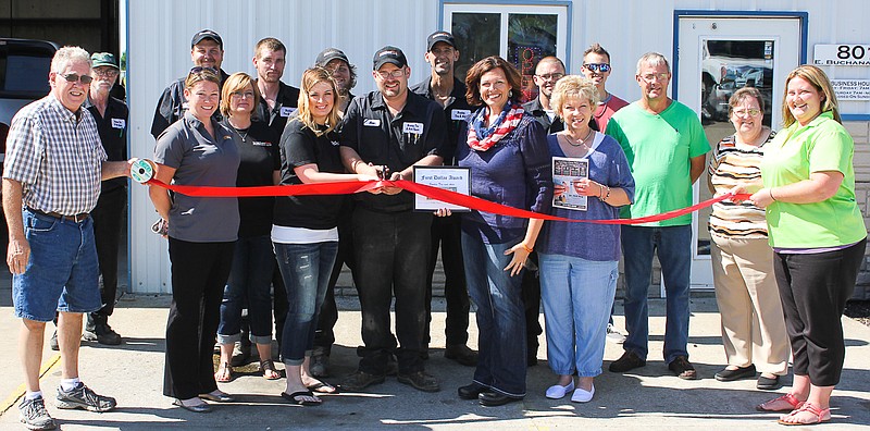 Brockes Tire & Auto owner, Adam Brockes, cuts the Chamber of Commerce ribbon. Members of the Chamber and the Brockes staff were present for the event.