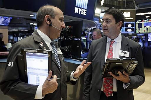 Traders Andrew Silverman, left, and Mark Muller work on the floor of the New York Stock Exchange, Tuesday, July 5, 2016.