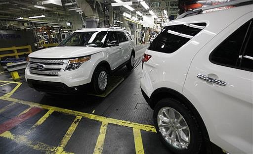 In this Dec. 1, 2010, file photo, plant employees drive 2011 Ford Explorer vehicles off the assembly line at Ford's Chicago Assembly Plant in Chicago. 
