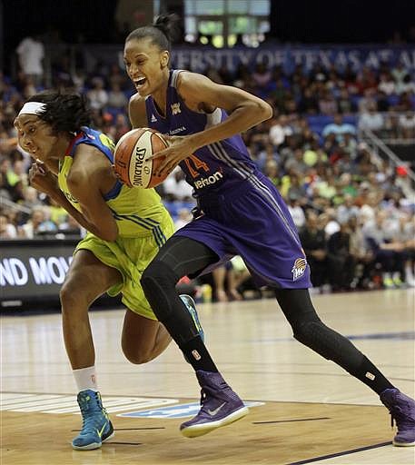 Phoenix Mercury guard DeWanna Bonner (24) drives against Dallas Wings forward Glory Johnson during the first half of a WNBA basketball game in Arlington, Texas, Tuesday, July 5, 2016. 