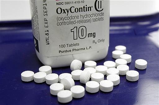 This Feb. 19, 2013, file photo, shows OxyContin pills arranged for a photo at a pharmacy in Montpelier, Vt. 