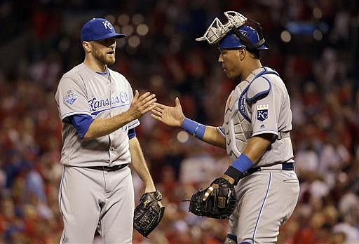 Kansas City Royals relief pitcher Wade Davis, left, and catcher Salvador Perez celebrate following the team's 4-2 victory over the St. Louis Cardinals in a baseball game Thursday, June 30, 2016, in St. Louis.