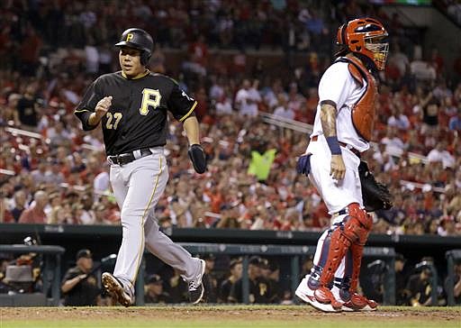 Pittsburgh Pirates' Jung Ho Kang, left, scores past St. Louis Cardinals catcher Yadier Molina during the sixth inning of a baseball game Wednesday, July 6, 2016, in St. Louis.
