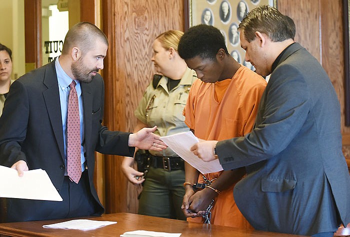 Charles Thompson's public defenders Walter Stokley, left, and David Wallis, right, talk to their client after sentencing by Judge Pat Joyce in Cole County Circuit Court on Wednesday, July 6, 2016. Thompson was found guilty on a burglary charge and pleaded guilty to charges surrounding a police chase while he was driving a stolen vehicle.