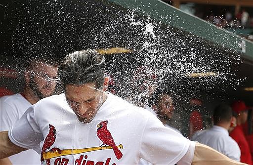 St. Louis Cardinals' Randal Grichuk is splashed with water by a teammate in celebration after Grichuk hit a solo home run during the fifth inning of a baseball game against the Pittsburgh Pirates Thursday, July 7, 2016, in St. Louis. 