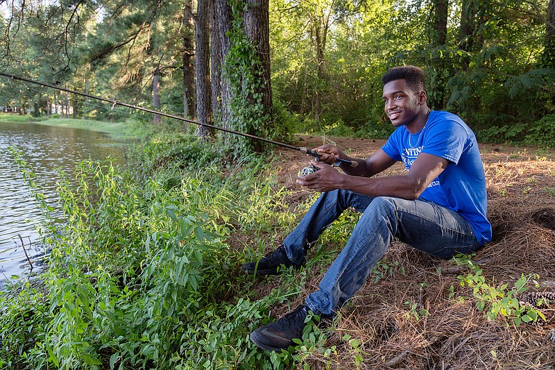 Montrell Estell poses for a portrait Thursday, July 7, 2016 at a family friend's house. Estell says that patience is important in both fishing and football. "You've got to wait for the play to start in football and in fishing you have to wait for the right fish to go by." 