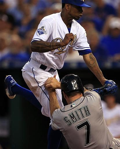 Seattle Mariners' Seth Smith (7) scores on a wild pitch by Kansas City Royals starting pitcher Yordano Ventura, top, during the sixth inning of a baseball game at Kauffman Stadium in Kansas City, Mo., Friday, July 8, 2016. 