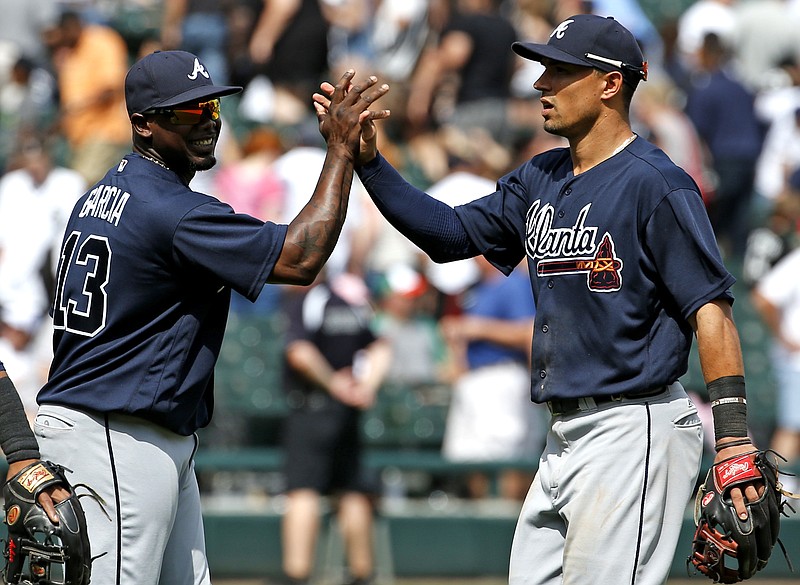 Atlanta Braves' Jace Paterson, right, celebrates with Adonis Garcia after they defeated the Chicago White Sox in an interleague baseball game in Chicago, Sunday, July 10, 2016. 