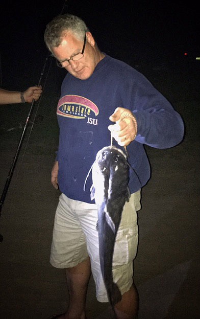 Bob Lambertz holds up the catfish that won family reunion bragging rights.