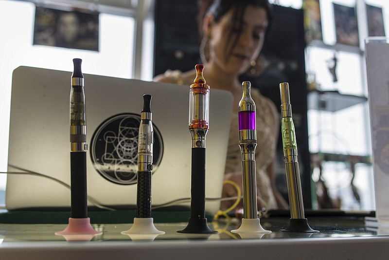 Vaporizers sit on display at the Brooklyn Vaper shop in the Brooklyn borough of New York, U.S., on Saturday, Feb. 8, 2014. Bloomberg Industries projects total U.S. e-cigarette sales could reach $1.5 billion this year. 