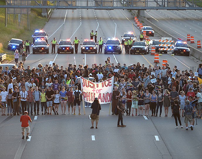 Protesters block part of Interstate 94 in St. Paul, Minnesota, on Saturday as police maintain their distance.