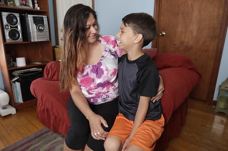 Raquel Vanderpool talks with her son, Tyler, Wednesday at home in Newport, Mich. The past didn't just repeat for Raquel so much as it rematerialized in a different form. She had been working as a nurse's aide for nearly a decade when a change in state law required her Michigan-based employer to conduct FBI fingerprint background checks. In Vanderpool's case, it turned up a conviction for falsifying a prescription for painkillers she'd received from a dentist when she was 20. Except it wasn't actually a conviction. That didn't prevent the mother of two from losing her job and plunging into an economic tailspin while she tried to clear up the confusion. 