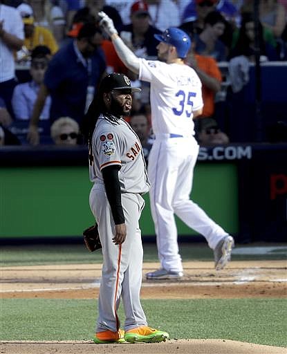 American League's Eric Hosmer, of the Kansas City Royals, crosses the plate after hitting a home run during the second inning of the MLB baseball All-Star Game, as National League's starting pitcher Johnny Cueto, of the San Francisco Giants, looks at the scoreboard Tuesday, July 12, 2016, in San Diego.