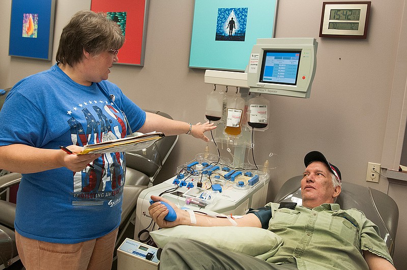 LifeShare Blood Center Tech Kindra Chittum, left, speaks with longtime blood donor Jimmy Roach Wednesday, July 13, 2016 during the Mash Bash Blood Drive at LifeShare Blood Center of Texarkana. The center hopes to collect 240 units of blood this week. The blood drive continues today.