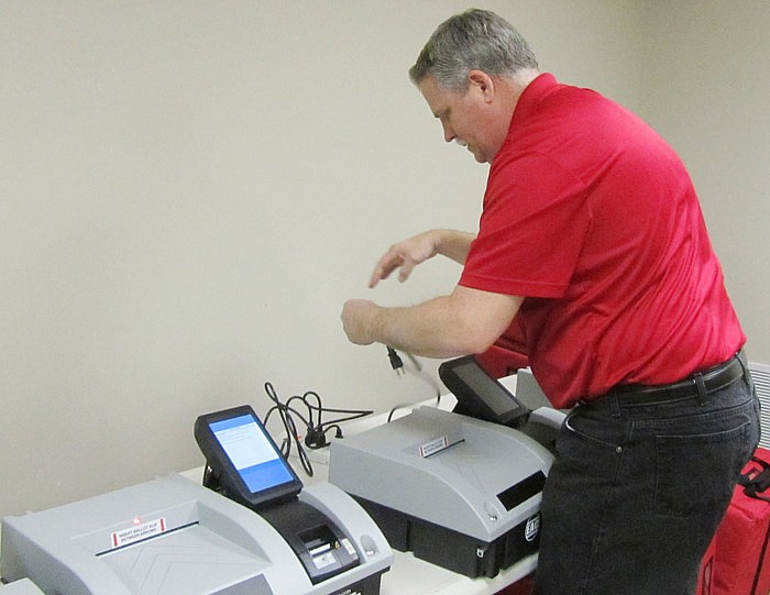 Cole County County Clerk Steve Korsmeyer plugs in voting machines to test them on Jan. 22, 2016. 