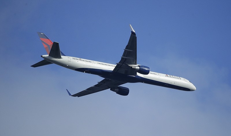 A Delta Air Lines Boeing 757 flies overhead Sunday, March 6, 2016, in Seattle. 