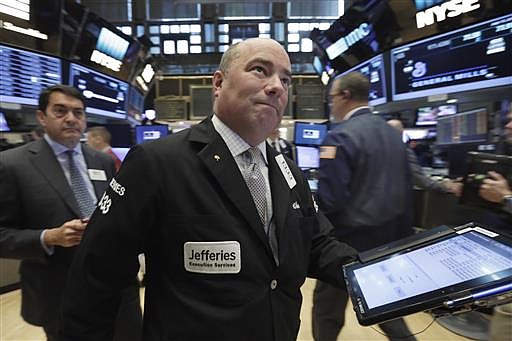 Trader Christopher Morie works on the floor of the New York Stock Exchange, Wednesday, July 13, 2016.