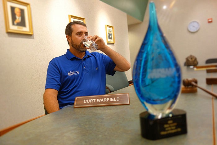 Curt Warfield, Kingdom City city manager, has a sip of water. Kingdom City was recognized as the 2016 Water System of the Year.