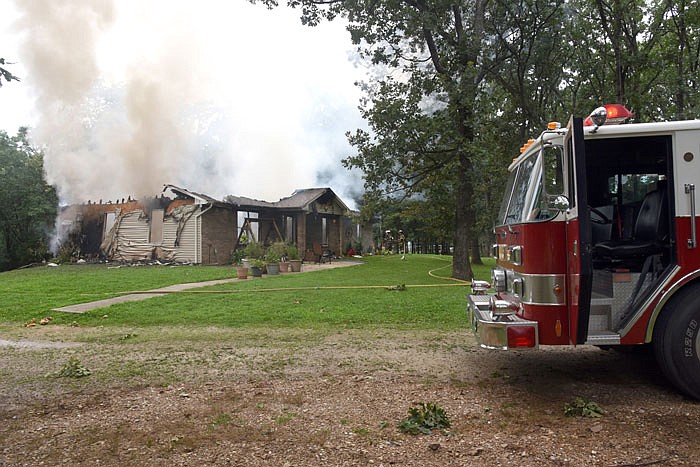 A structure fire burns Thursday in Russellville. Neighbors saw the fire and called the homeowners, who were not present during the fire. 