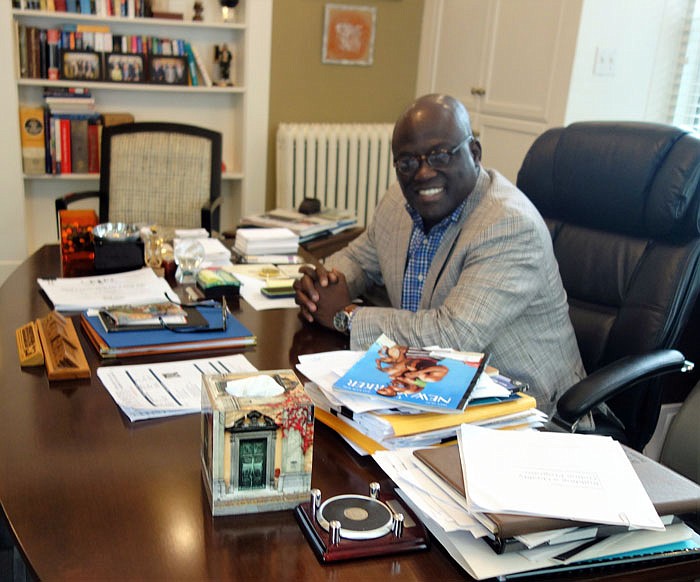 Benjamin Ola. Akande sits at his desk on Tuesday morning in Fulton.
