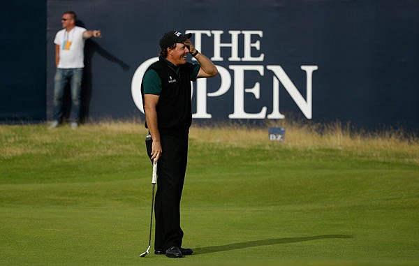 Phil Mickelson reacts as he narrowly misses a birdie putt on the 18th green Thursday during the first round of the British Open at the Royal Troon Golf Club in Troon, Scotland.