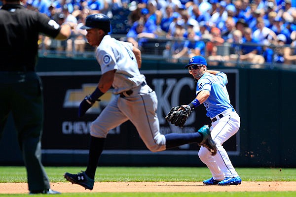 Royals second baseman Whit Merrifield throws to force out Ketel Marte of the Mariners during a game at Kauffman Stadium in Kansas City. The Royals start the second half of the season today in Detroit.