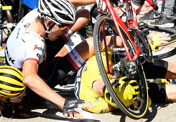 Chris Froome, wearing the overall leader's yellow jersey, Bauke Mollema (center) and Richie Porte crash Thursday at the end of the 12th stage of the Tour de France.