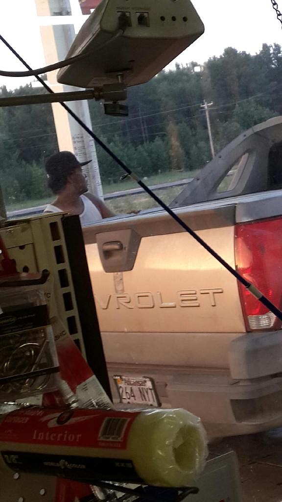 In this photo provided by Jimmy Sparks, Andre Johnson, 40, is seen standing next to a pickup on July 9 at the Eagle Cash Grocery in Eagletown, Okla., after he allegedly fatally shot his mother and uncle. In less than an hour after Parks submitted this image to officials, Oklahoma officers were in pursuit and Johnson was fatally shot. 
