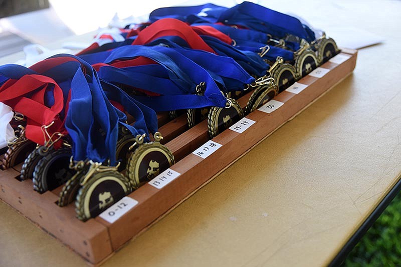 Medals wait for their new owners at the 10th Annual Kyle Billington Memorial 5K Run/Walk in Jefferson City on Saturday, July 16, 2016. Kyle Billington died in a single car accident in 2006 and his family created the 5K in his memory. This is the last year for the run/walk. 