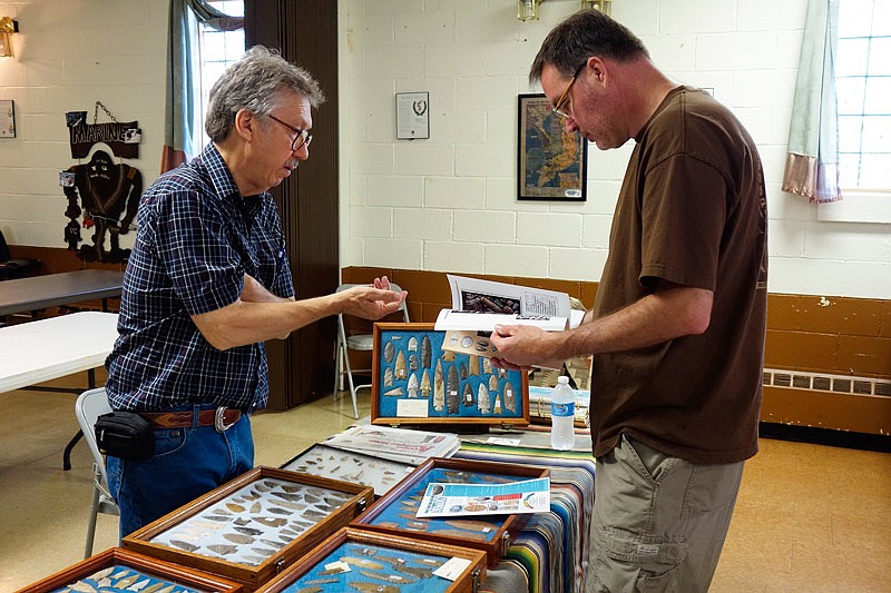 Dave Koch, right, talks artifacts at Fulton VFW Post 2657 on Saturday, July 16, 2016 with Dennis Arbeiter, who runs Rainbow Traders in Godfrey, Illinois.