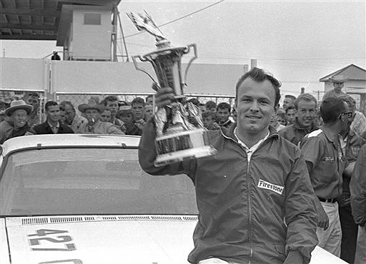 In this Feb. 14, 1965, file photo, Fred Lorenzen, of Elmhurst, Ill., gives a victory wave after winning the Daytona 500 mile stock car auto race which was halted by rain at the end of 133 laps, in Daytona Beach, Fla. He was one of NASCAR's first superstars, but Lorenzen's memories of his Hall of Fame career have dimmed as he battles dementia. Now, Lorenzen has pledged his brain to the Concussion Legacy Foundation. He joins Dale Earnhardt Jr. as the only NASCAR drivers to make the pledge.