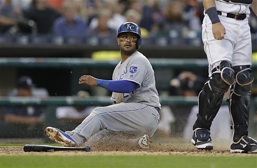 Kansas City Royals Christian Colon safely slides home from second on a single by Jarrod Dyson during the fifth inning of a baseball game against the Detroit Tigers, Saturday, July 16, 2016 in Detroit. (AP Photo/Carlos Osorio)