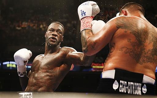 Deontay Wilder throws a left at Chris Arreola during the WBC heavyweight title boxing bout Saturday, July 16, 2016, in Birmingham, Ala.