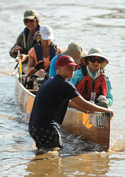 Hunter Thornsberry helps guide a four-person canoe to the riverbank as paddler at the conclusion of a previous MR 340.

