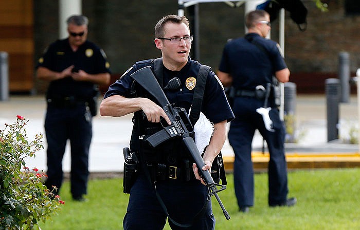 Police guard the emergency room entrance to the hospital where wounded officers were taken in Baton Rouge after three policemen were killed Sunday, July 17, 2016.