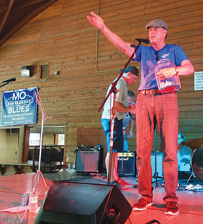 Chuck Renn of the MO Blues Association raffles off prizes at Blue Sunday, the group's annual free live music event.