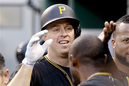 Pittsburgh Pirates' Erik Kratz, left, is greeted by Starling Marte in the dugout after hitting a solo home run off San Francisco Giants starting pitcher Madison Bumgarner in the fifth inning of a baseball game, Monday, June 20, 2016, in Pittsburgh.