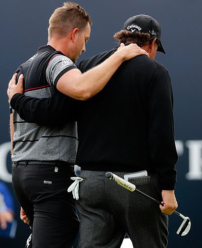 Henrik Stenson and Phil Mickelson walk off the 18th green Sunday at the British Open in Troon, Scotland.